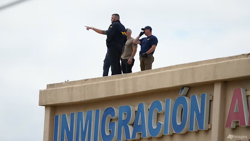 Law enforcement agents look around the roof of an apartment building near the scene of a shooting at a US Immigration and Customs Enforcement office in Dallas on Sep 24, 2025. (Photo: AP Photo/Julio Cortez)