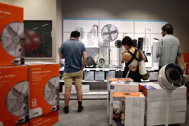 File Photo: People browse fans and air conditioning units in a homeware store, amid a heatwave in Paris, France, May 28, 2026. REUTERS/Tom Nicholson/File Photo/File Photo
