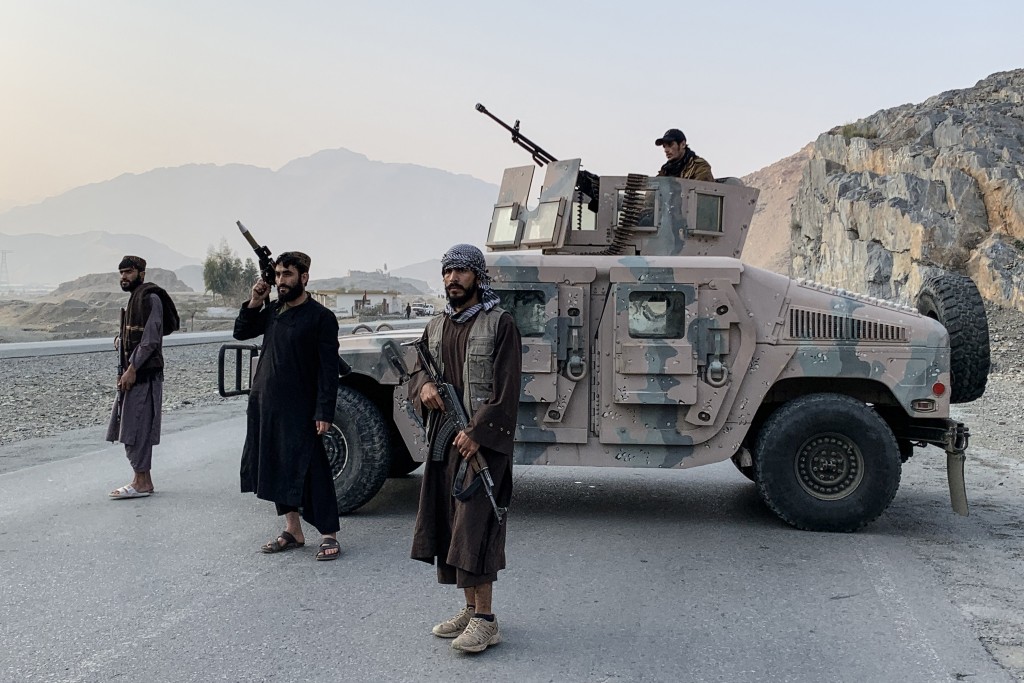 Photo by AIMAL ZAHIR / AFP  Taliban security personnel stand guard near the Torkham border crossing between Afghanistan and Pakistan in the Nangarhar province on February 27, 2026.
