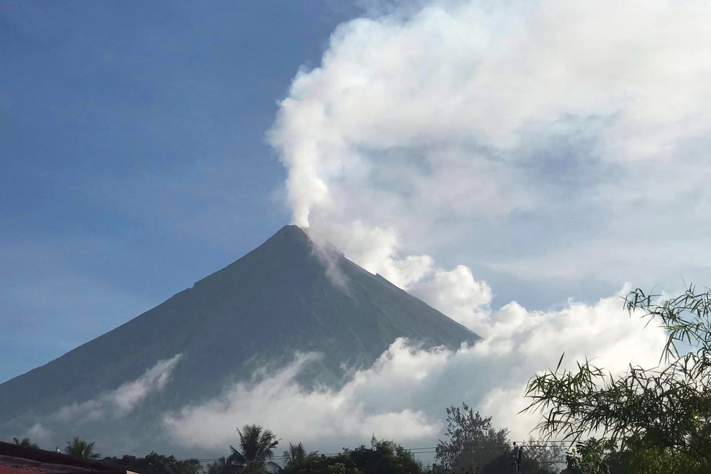 This handout photo made available by Kristin Moral shows the Mount Mayon spewing white smoke as seen from Camalig on June 8, 2023. (Kristin Moral / AFP) This handout photo made available by Kristin Moral shows the Mount Mayon spewing white smoke as seen from Camalig on June 8, 2023. (Kristin Moral / AFP)