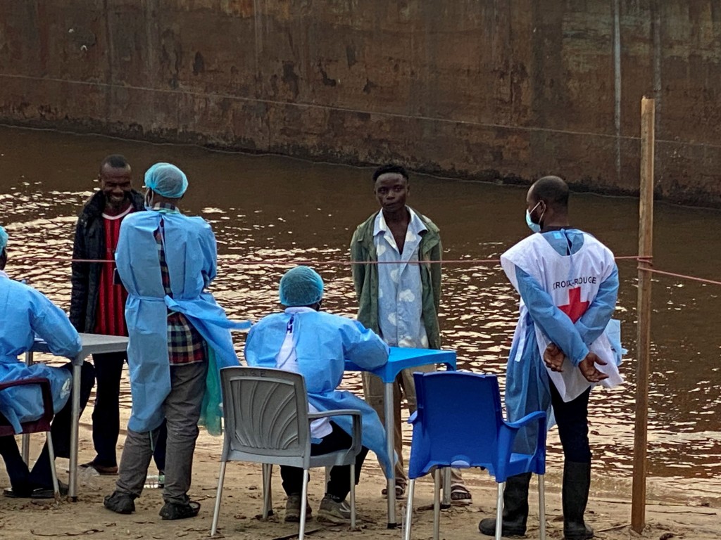 Passengers who disembarked from a boat intercepted by health authorities wait to be tested following the death of a passenger suspected of having Ebola, in Kinshasa, Democratic Republic of the Congo. (Reuters)