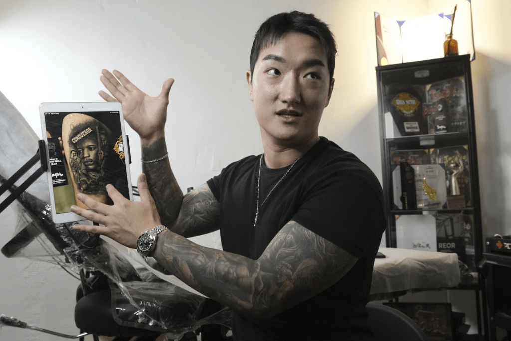 Tattoo artist Song Jaemin speaks during an interview with The Associated Press at his studio in Goyang, South Korea, Thursday, Sept. 18, 2025. (AP Photo/Ahn Young-joon)