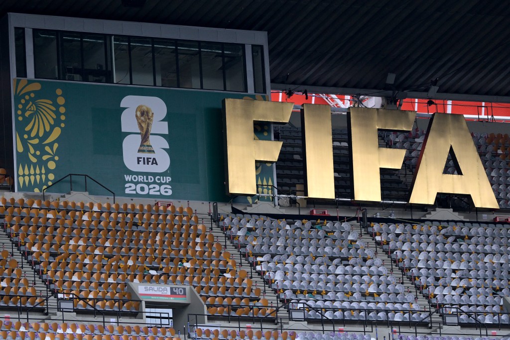 A FIFA logo is pictured on the stands as South Africa's players take part in a pitch recognition at the Mexico City Stadium in Mexico City on June 10, 2026, on the eve of the 2026 World Cup football match between Mexico and South Africa. (Photo by Alfredo ESTRELLA / AFP)