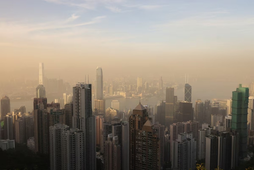 Victoria Harbour and the Central Business District are in a haze as the sun sets over Hong Kong, China April 14, 2025. REUTERS