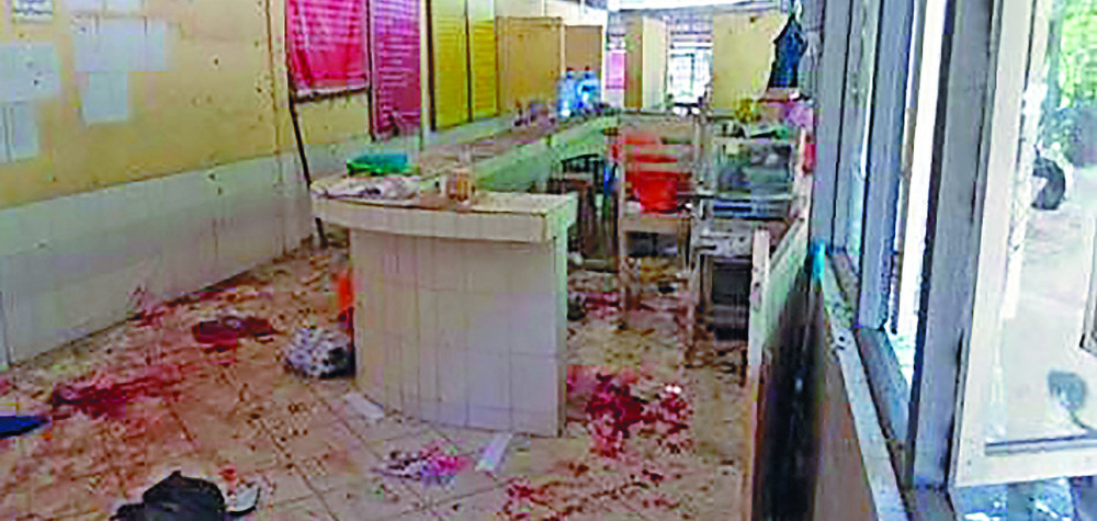 A photo provided by the Military True News Information Team shows a parcel-reception desk at the entrance of the Insein prison after an explosion. A photo provided by the Military True News Information Team shows a parcel-reception desk at the entrance of the Insein prison after an explosion.