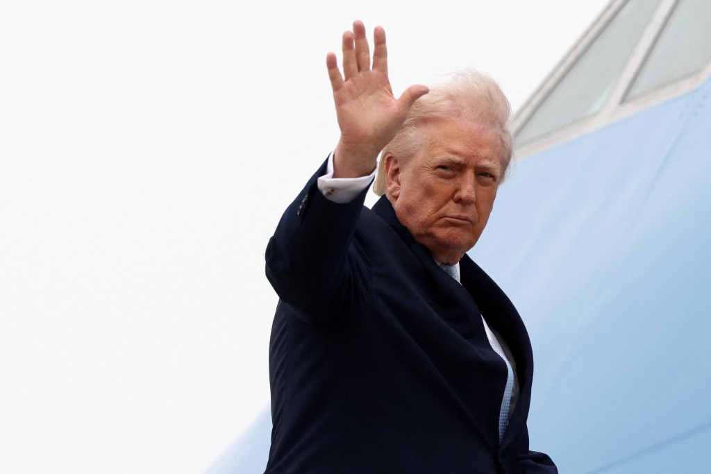 U.S. President Donald Trump gestures while boarding Air Force One as he departs from Joint Base Andrews in Maryland, U.S., March 20, 2026. (Reuters)