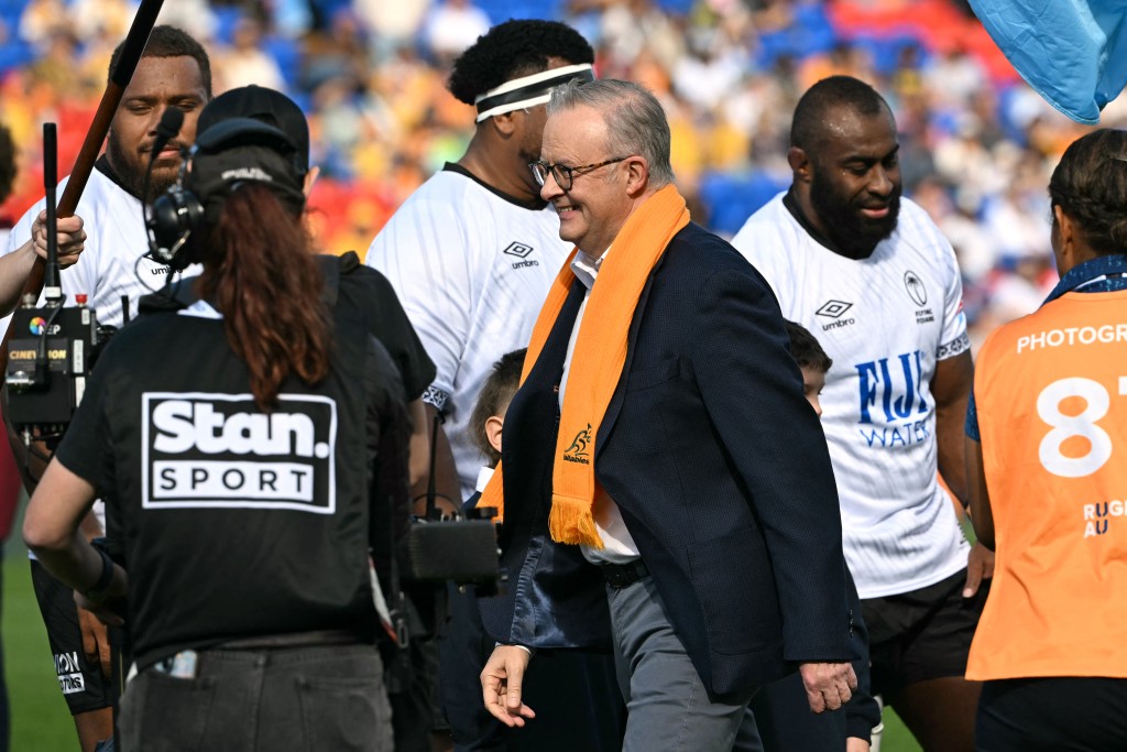 Prime Minister of Australia Anthony Albanese (C) shakes hands with players from Fiji before the start of the rugby union Test match between Australia and Fiji in Newcastle on July 6, 2025. (AFP)