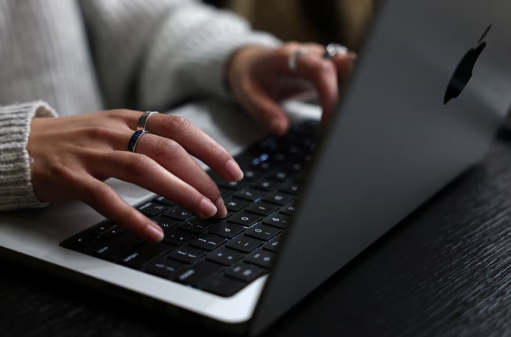 A person works on their laptop at a cafe in London, Britain, October 21, 2026. Government websites across Europe went dark on Wednesday as operators raced to patch two critical vulnerabilities in PHP, one of the most widely used programming languages on the web. REUTERS/Toby Melville