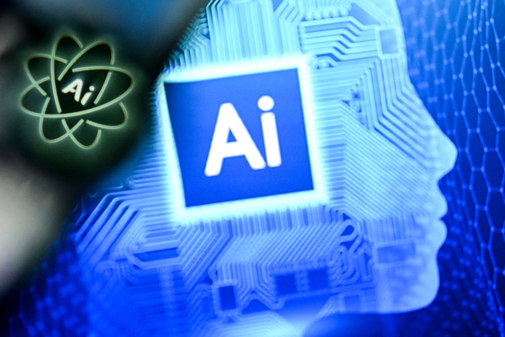 Photo by KIRILL KUDRYAVTSEV / AFP. A photo taken on January 2, 2025 shows the letters AI for Artificial Intelligence on a laptop screen (R) next to the logo of the Chat AI application on a smartphone screen in Frankfurt am Main, western Germany.