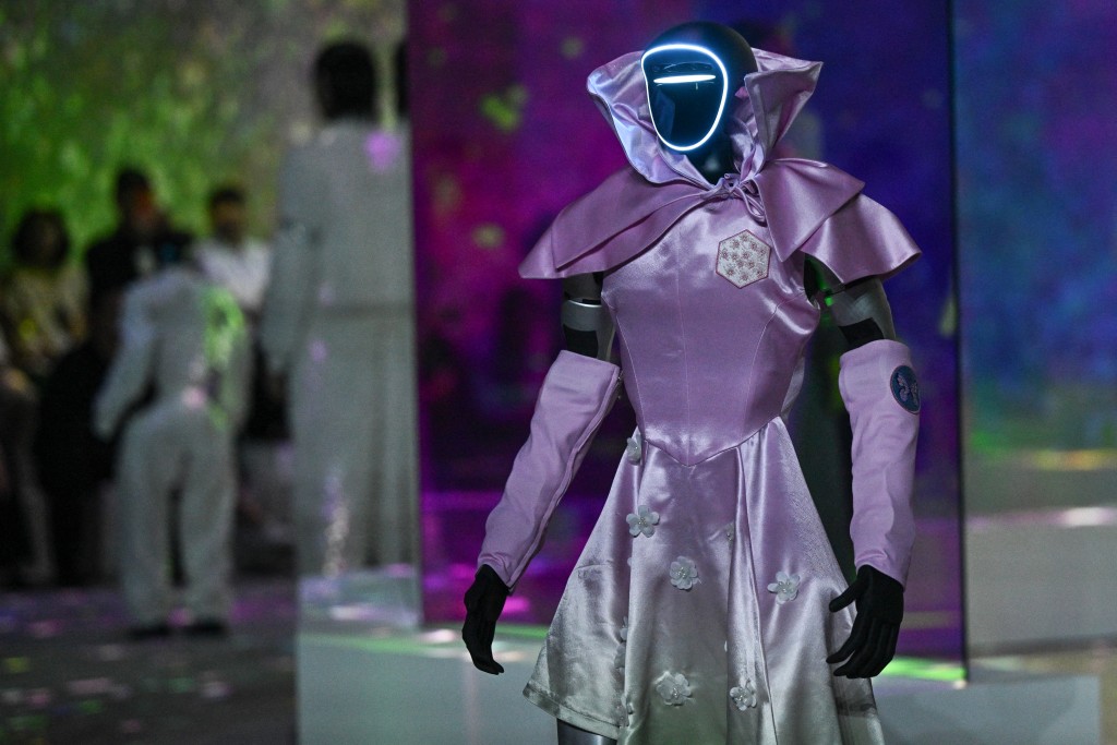 A humanoid robot presents creations at Galaxy Corporation's "Mach33: Physical AI Fashion Show" in seoul on May 28, 2026. (Photo by Pedro PARDO / AFP)