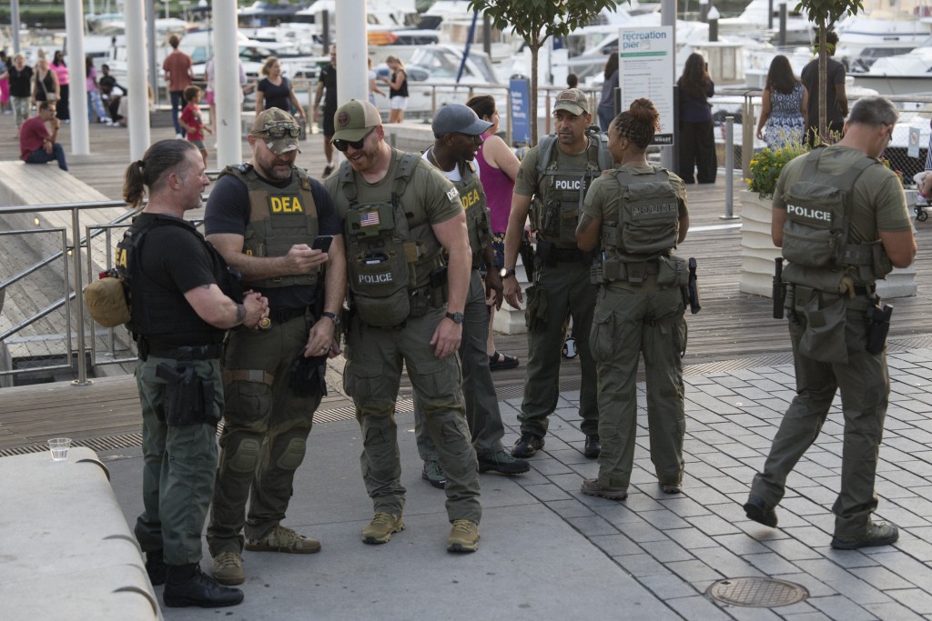WASHINGTON, DC - AUGUST 14: Drug Enforcement Agents walk along The Wharf on August 14, 2025 in Washington, DC. U.S. President Donald Trump announced plans to deploy federal officers and the National Guard to the District in order to place the DC Metropolitan Police Department under federal control and assist in crime prevention in the nation's capital. Kayla Bartkowski/Getty Images/AFP (Photo by Kayla Bartkowski / GETTY IMAGES NORTH AMERICA / Getty Images via AFP)