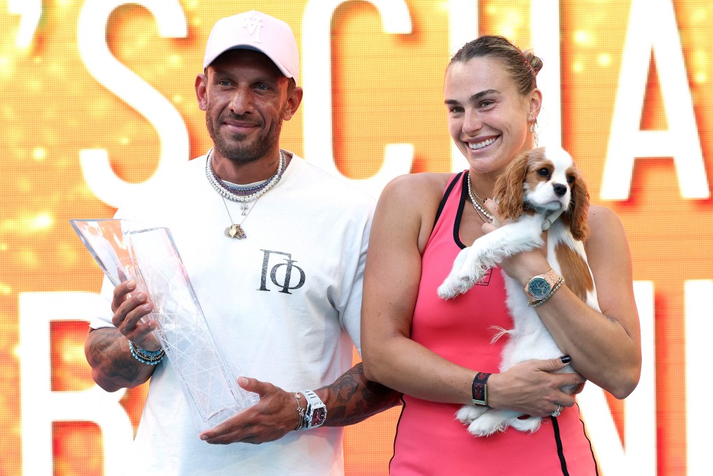 Aryna Sabalenka celebrates her triumph with fiance Georgios Frangulis and her dog Ash. AFP 