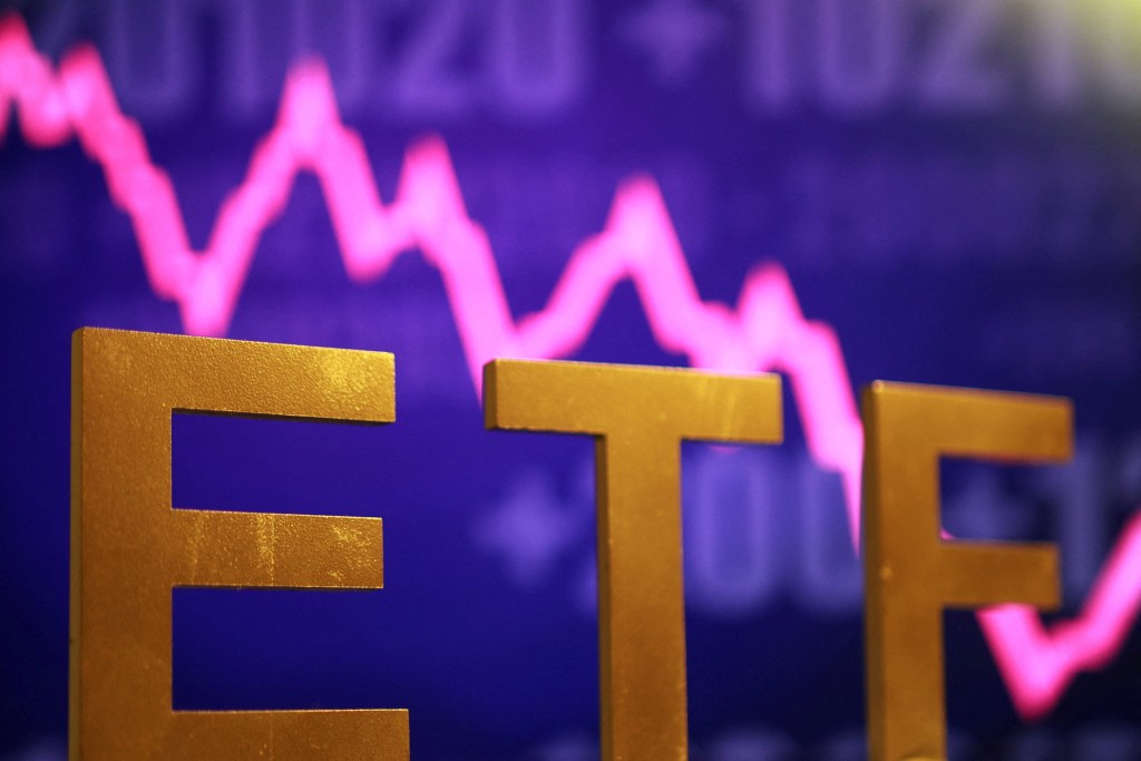 A 3D printed word "ETF (Exchange-Traded Fund)" is seen in front of decreasing stock graph in this illustration taken October 16, 2025. REUTERS/Dado Ruvic/Illustration