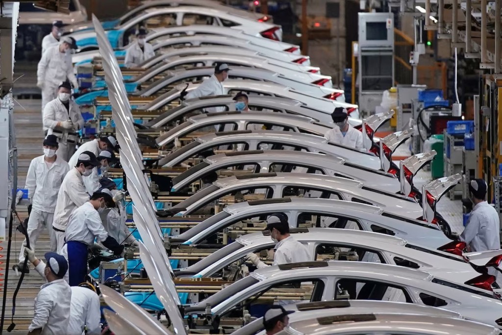 Employees work on a production line inside a Dongfeng Honda factory in Wuhan, China, April 8, 2020. REUTERS