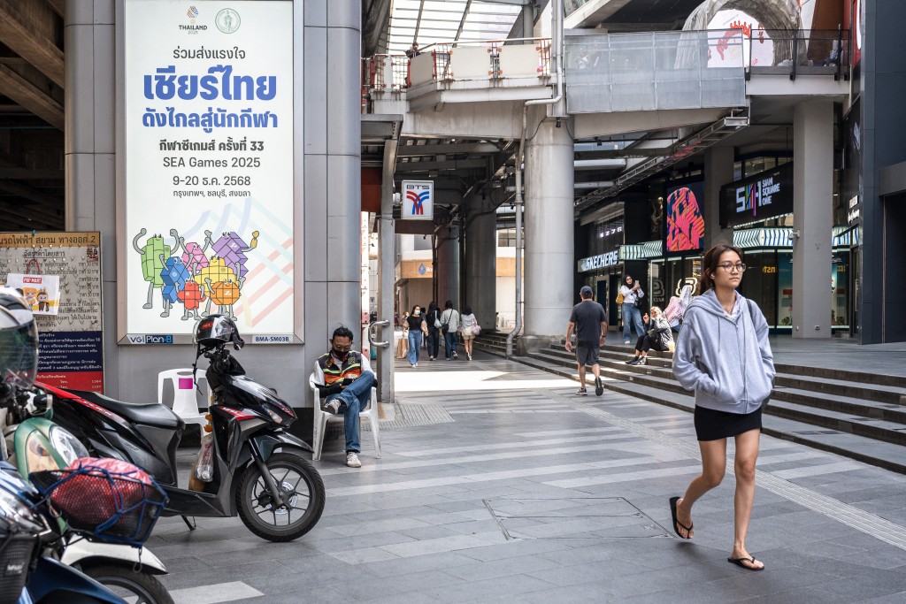 Photo by CHANAKARN LAOSARAKHAM / AFP  A placard promoting Thai athletes at the 33rd SEA Games is pictured in downtown Bangkok on November 28, 2025.