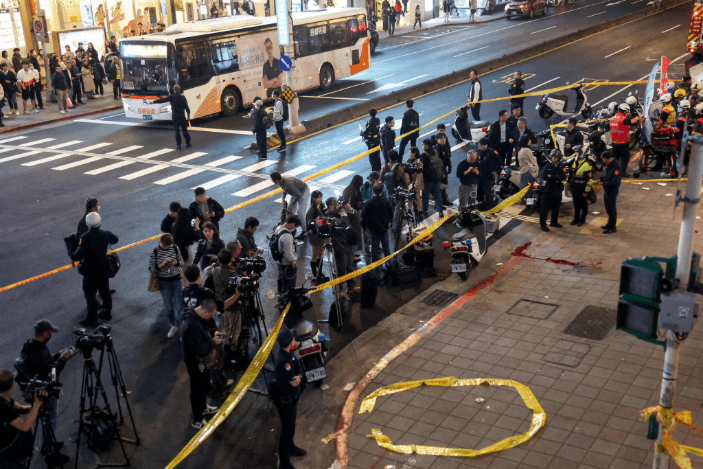Media members stand outside Eslite Spectrum Nanxi store near Zhongshan station as the entrance of the building is cordoned off with yellow crime scene tape, following an incident in which several were injured after a person released smoke bombs and attacked bystanders, according to the government and local media, in Taipei, Taiwan, December 19, 2025. REUTERS/Ann Wang