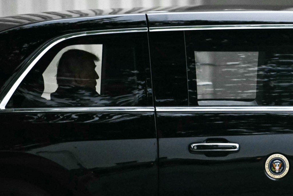 Photo by KENT NISHIMURA / AFP  US President Donald Trump rides in his motorcade as he departs after a visit to Walter Reed National Military Medical Center in Bethesda, Maryland, on May 26, 2026.