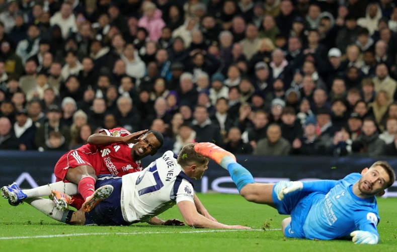 Alexander Isak, left, picks up an injury in a challenge from Tottenham's Micky van de Ven as he scores a goal. AP