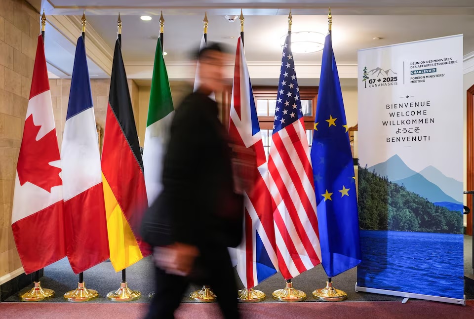 A man walk past the G7 members flags at the Manoir Richelieu before the G7 Foreign Ministers summit in La Malbaie, Quebec, Canada March 12, 2025. REUTERS/Mathieu Belanger A man walk past the G7 members flags at the Manoir Richelieu before the G7 Foreign Ministers summit in La Malbaie, Quebec, Canada March 12, 2025. REUTERS/Mathieu Belanger