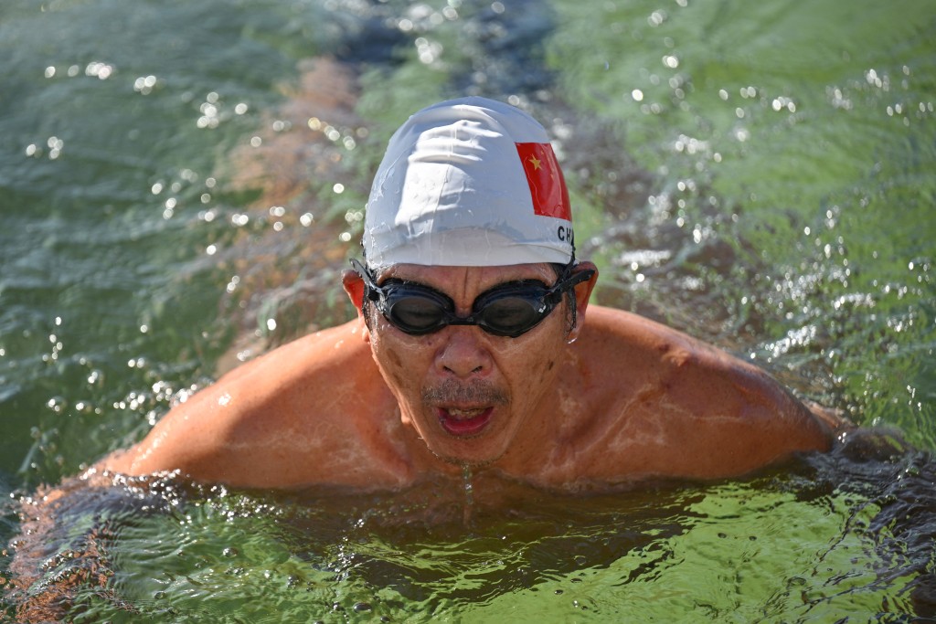 Photo by ADEK BERRY / AFP  A winter swimming enthusiast swims at the Houhai Lake of the Shichahai scenic area in Beijing on January 20, 2026.