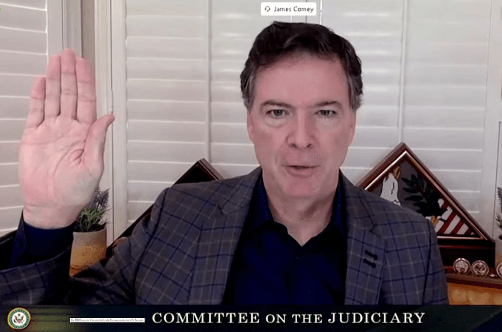 James Comey, former director of the Federal Bureau of Investigation (FBI), is seen in a frame grab from a video feed as he is sworn in remotely from his home during a Senate Judiciary Committee hearing exploring the FBI's investigation of the 2016 Trump campaign and Russian election interference in Washington, U.S., September 30, 2020. U.S. Senate Committee on the Judiciary/Handout via REUTERS/File Photo