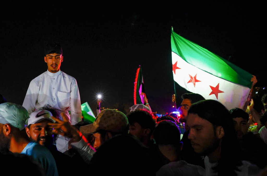People celebrate after U.S. President Donald Trump said on Tuesday he would order the lifting of sanctions on Syria, in Damascus, Syria May 13 , 2025. (Reuters)