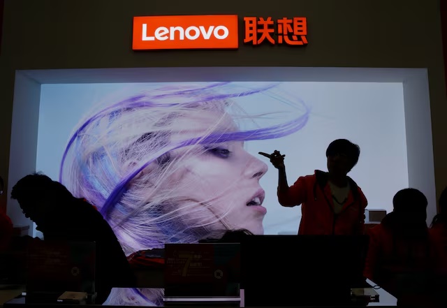 An employee gestures next to a Lenovo logo at Lenovo Tech World in Beijing, China November 15, 2019. REUTERS/Jason Lee/ File Photo