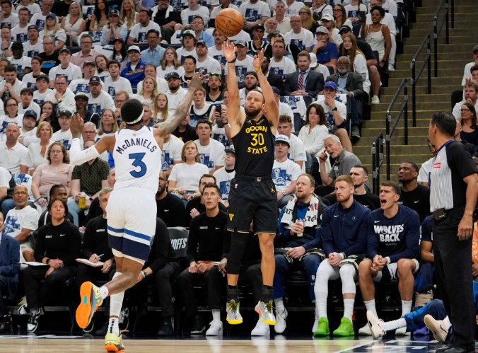 Steph Curry shoots over Minnesota Timberwolves forward Jaden McDaniels in Game One. AP 
