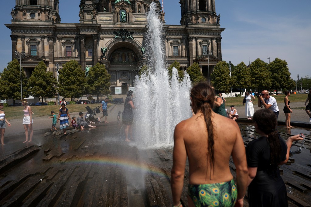 People cool off in the fountain in front of the Berlin Cathedral Berliner Dom during the ongoing heatwave in Berlin, Germany (Reuters)