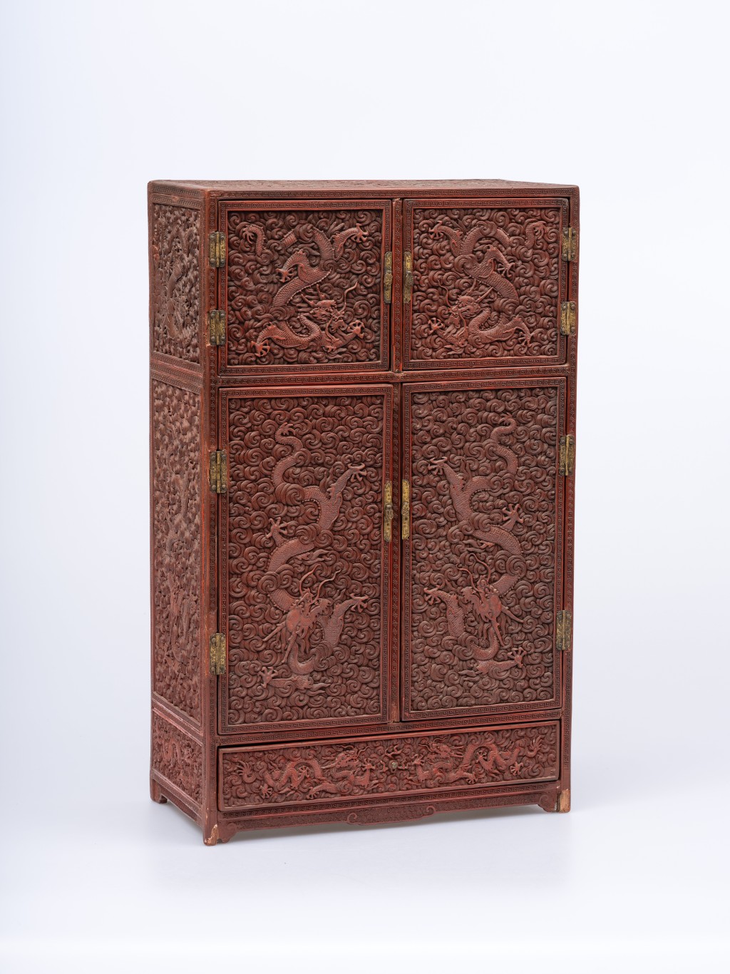 Carved red lacquer cabinet with dragon and cloud design
