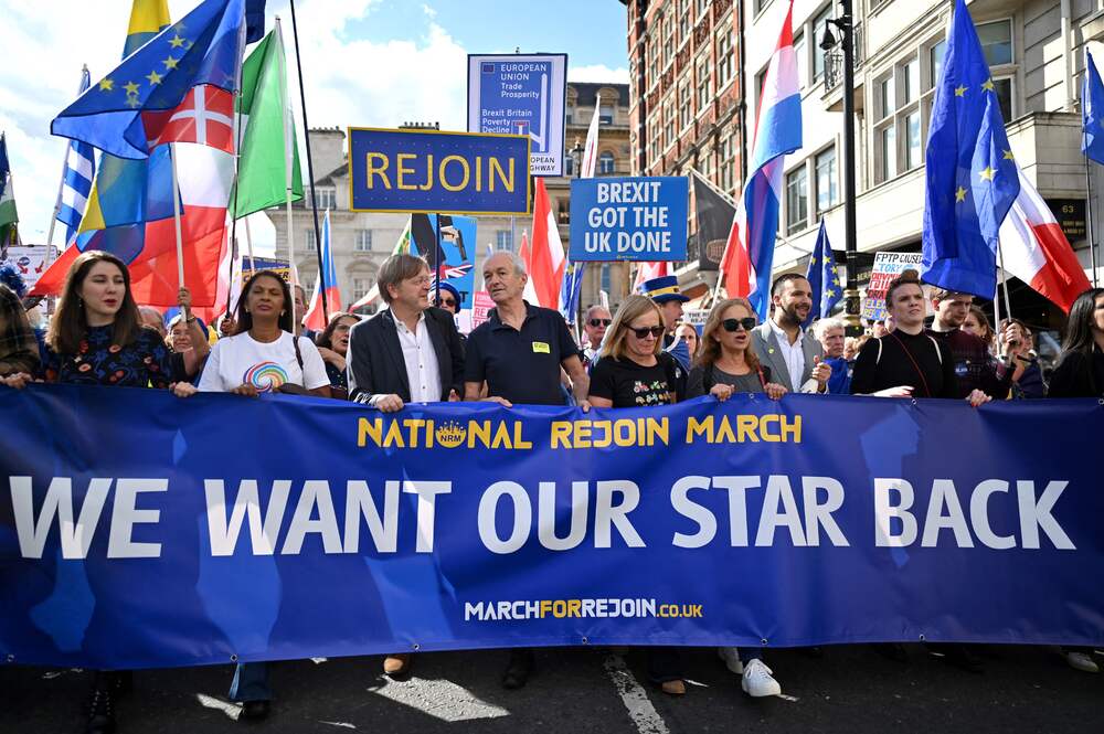 European MP and former Brexit negotiator Guy Verhofstadt, third left, and anti-Brexit campaigner Gina Miller, second left, take part in a rally calling for the UK to rejoin the EU. AFP European MP and former Brexit negotiator Guy Verhofstadt, third left, and anti-Brexit campaigner Gina Miller, second left, take part in a rally calling for the UK to rejoin the EU. AFP