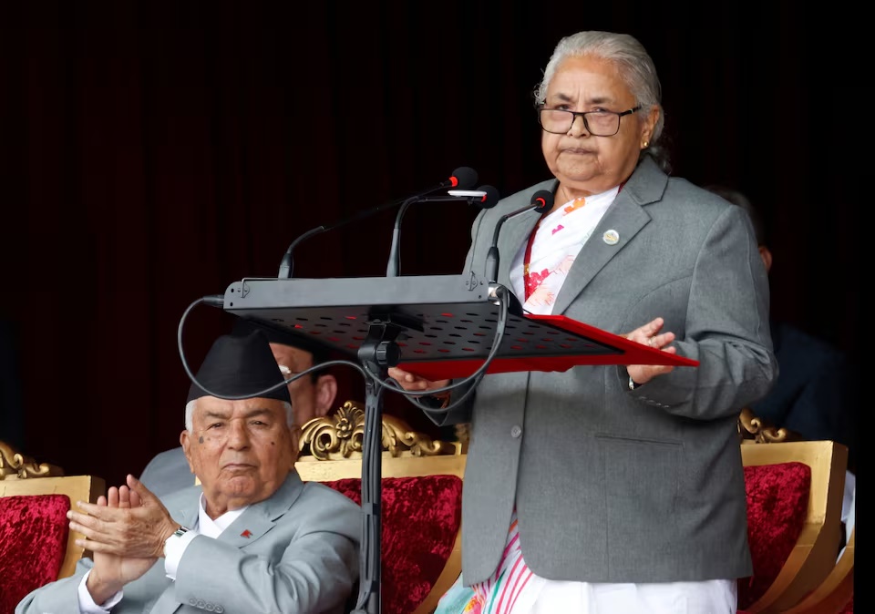 Nepal's interim Prime Minister Sushila Karki addresses as President Ram Chandra Paudel applauds while attending the Constitution Day at the Army Pavilion in Tundikhel, Kathmandu, Nepal, September 19, 2025. REUTERS/Stringer