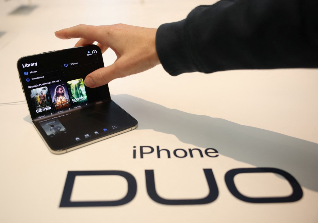 A person uses the new foldable iPhone Duo, on its launch day at an Apple store, in London, Britain, October 23, 2026. REUTERS