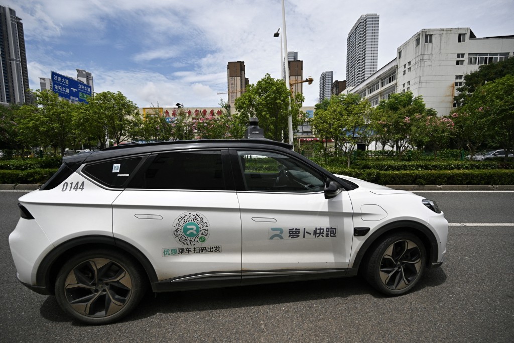 Photo by PEDRO PARDO / AFP  This file photo taken on August 1, 2024 shows a general view of a driverless robotaxi autonomous vehicle developed as part of tech giant Baidu's Apollo Go self-driving project, in Wuhan, in central China's Hubei province.