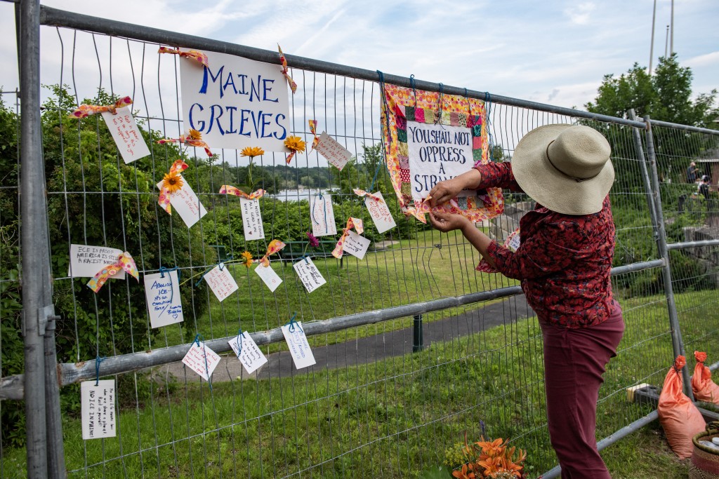 Photo by JOSEPH PREZIOSO / AFP  People hang messages on a fence during a vigil honoring a 26-year-old Colombian man who was fatally shot during an Immigration and Customs Enforcement (ICE) operation in Biddeford, Maine, on July 13, 2026.