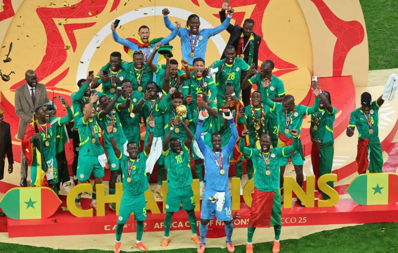 Senegal's Sadio Mane holds the trophy aloft as he celebrates with teammates. AP 