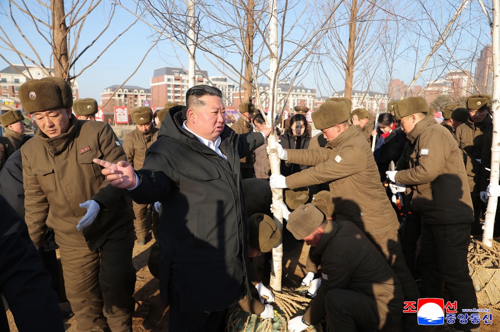 This picture taken on January 5, 2026 and released by North Korea's official Korean Central News Agency (KCNA) via KNS on January 6, 2026 shows North Korean leader Kim Jong Un (C) planting a tree at the construction site of the Memorial Museum of Combat Feats at the Overseas Military Operations in Pyongyang. (Photo by AFP)