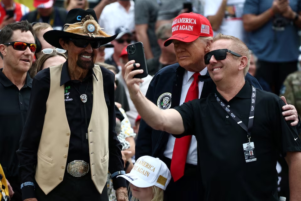 Donald Trump takes a selfie with former NASCAR Cup series driver, Greg Biffle and NASCAR Hall of Famer, Richard Petty in Daytona Beach, Florida. (Reuters)