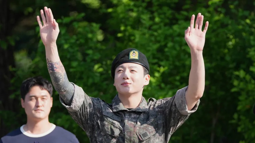K-pop band BTS members Jung Kook waves after being discharged from a mandatory military service in Yeoncheon, South Korea, Wednesday, June 11, 2025. (AP Photo/Lee Jin-man)