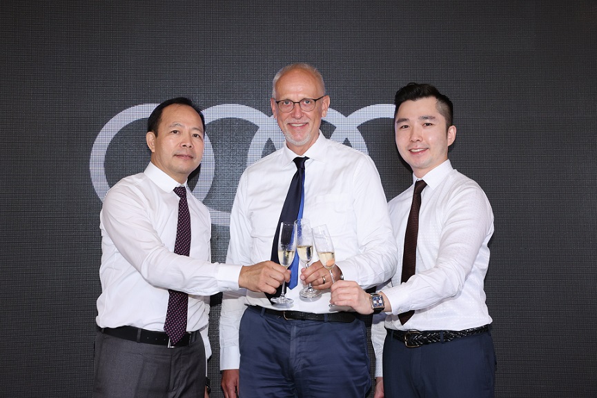 Lothar Korn, center, the Managing Director of Audi Hong Kong, Hing Tak Mak, left, President of Kam Lung Motor Group, and John Leung, General Manager of Audi at Kam Lung Motors, announce a partnership.
