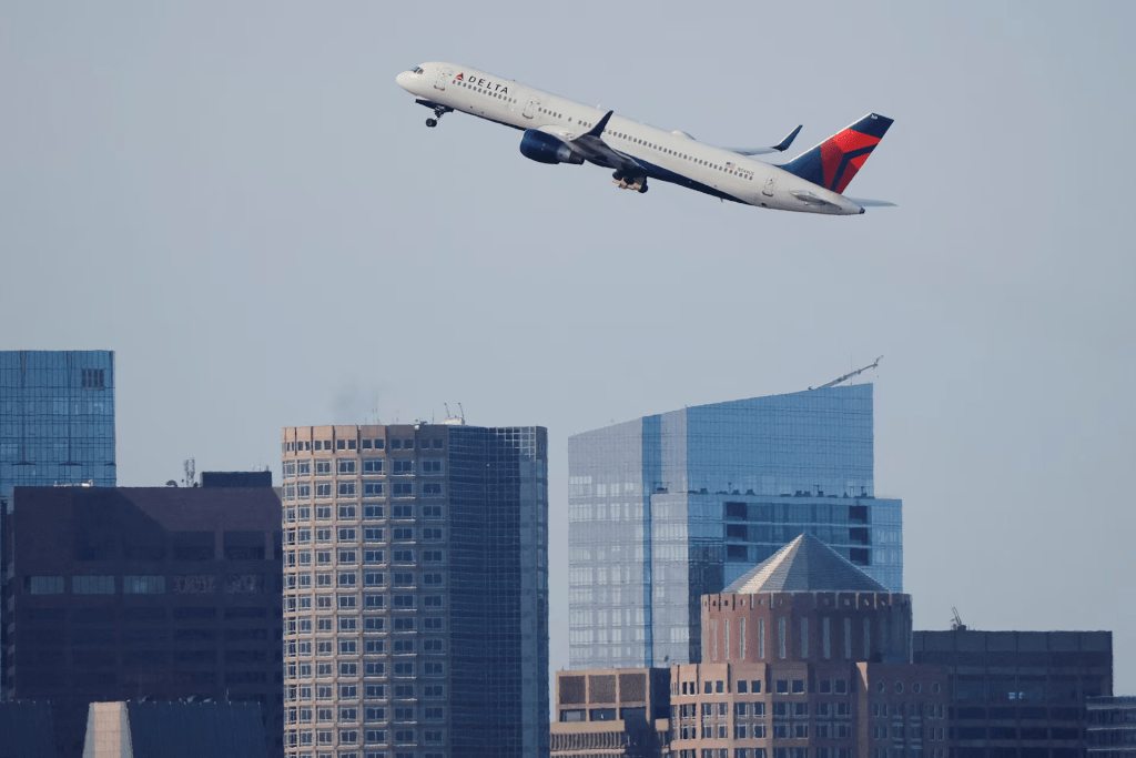 A Delta Airlines flight takes off from Logan International Airport, as airlines cancelled flights at 40 major airports after the government imposed an unprecedented cut to air travel, citing air traffic control safety concerns because of a record-setting government shutdown, in Boston, Massachusetts, U.S., November 7, 2025. REUTERS/Brian Snyder