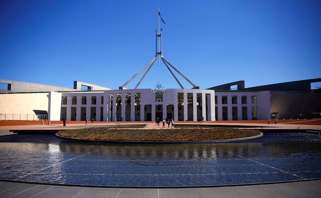 Tourists walk around the forecourt of Australia's Parliament House in Canberra, Australia, October 16, 2017. REUTERS/David Gray/Files