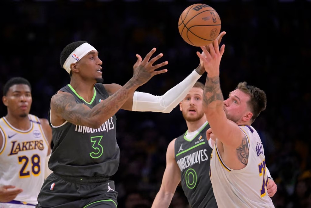 Los Angeles Lakers guard Luka Doncic (77) iand Minnesota Timberwolves guard Joe Ingles (7) reach for a loose ball in the first half at Crypto.com Arena. (Reuters)