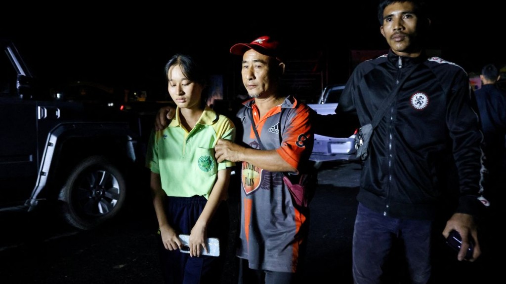 A girl evacuates from Patongprathankiriwat School, where she had been hiding during an incident. Reuters