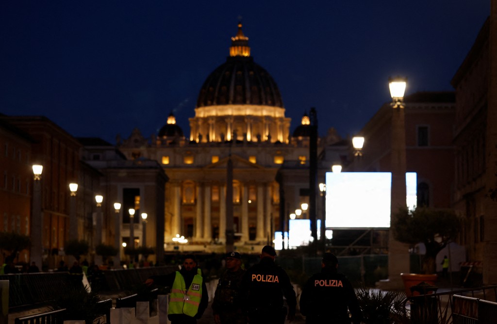 Police officers patrol, with the St. Peter's Basilica in the background, on the day Pope Leo XIV holds his inaugural Mass at the Vatican, as seen from Rome, Italy, May 18, 2025. (Reuters)