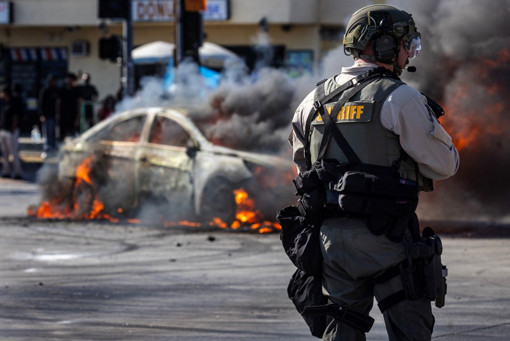 Smoke rises from a burning car on Atlantic Boulevard, during a standoff by protesters and law enforcement, following multiple detentions by Immigration and Customs Enforcement (ICE), in the Los Angeles County city of Paramount, California, U.S., June 7, 2025. (Reuters)
