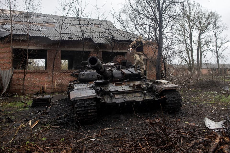 A Ukrainian soldier jumps off a destroyed Russian tank on the outskirts of the village of Mala Rohan, amid Russia's invasion of Ukraine, in Kharkiv region, Ukraine. (Reuters) A Ukrainian soldier jumps off a destroyed Russian tank on the outskirts of the village of Mala Rohan, amid Russia's invasion of Ukraine, in Kharkiv region, Ukraine. (Reuters)