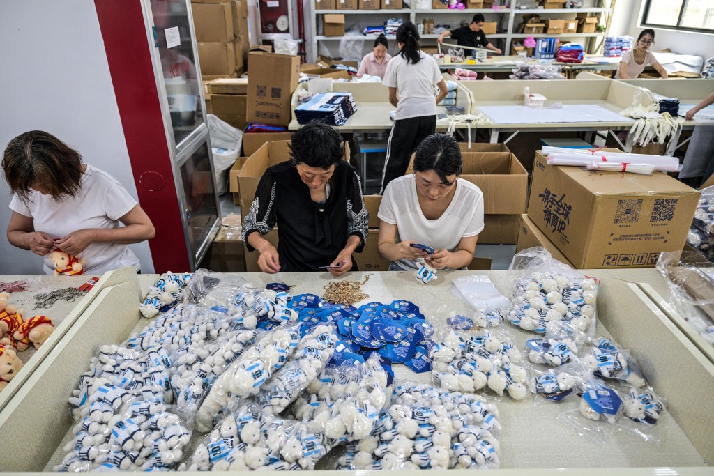 Photo by HECTOR RETAMAL / AFP  In this photo taken on June 5, 2026, workers pack merchandise of Lionel Messi of Argentina's national football team, which will participate in the FIFA World Cup 2026, at the All Star Partner factory in Yiwu in eastern China's Zhejiang province.