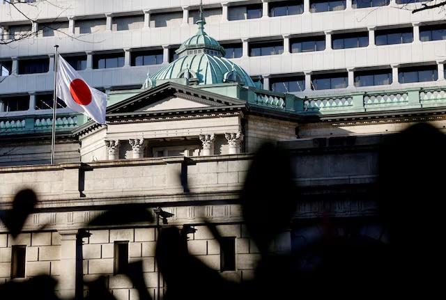 A Japanese flag flutters atop the Bank of Japan headquarters in Tokyo, Japan, December19, 2025. REUTERS/Manami Yamada/File Photo