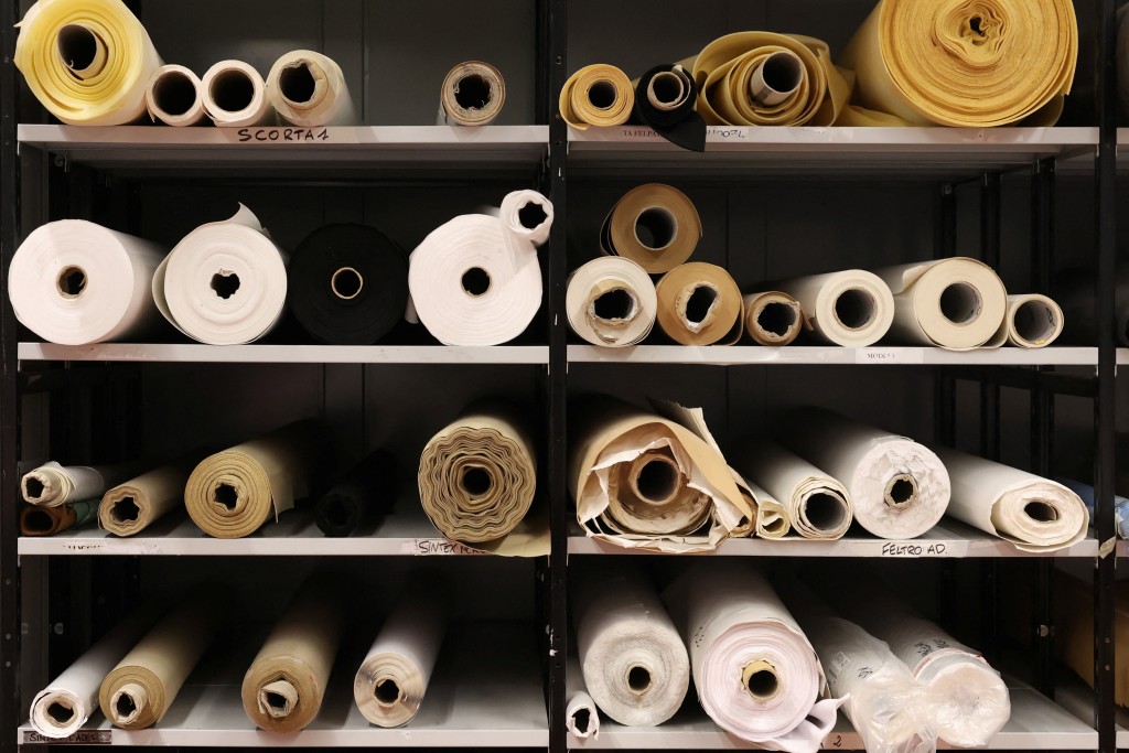 Rolls of leather lay on shelves at the Italian group factory, which hosts the production and development of Prada and Miu Miu's leather goods collections, in Scandicci, near Florence, Italy, November 28, 2025. REUTERS/Claudia Greco